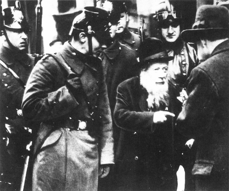 An elderly Jew being taken into custody by police in Berlin, 1934
